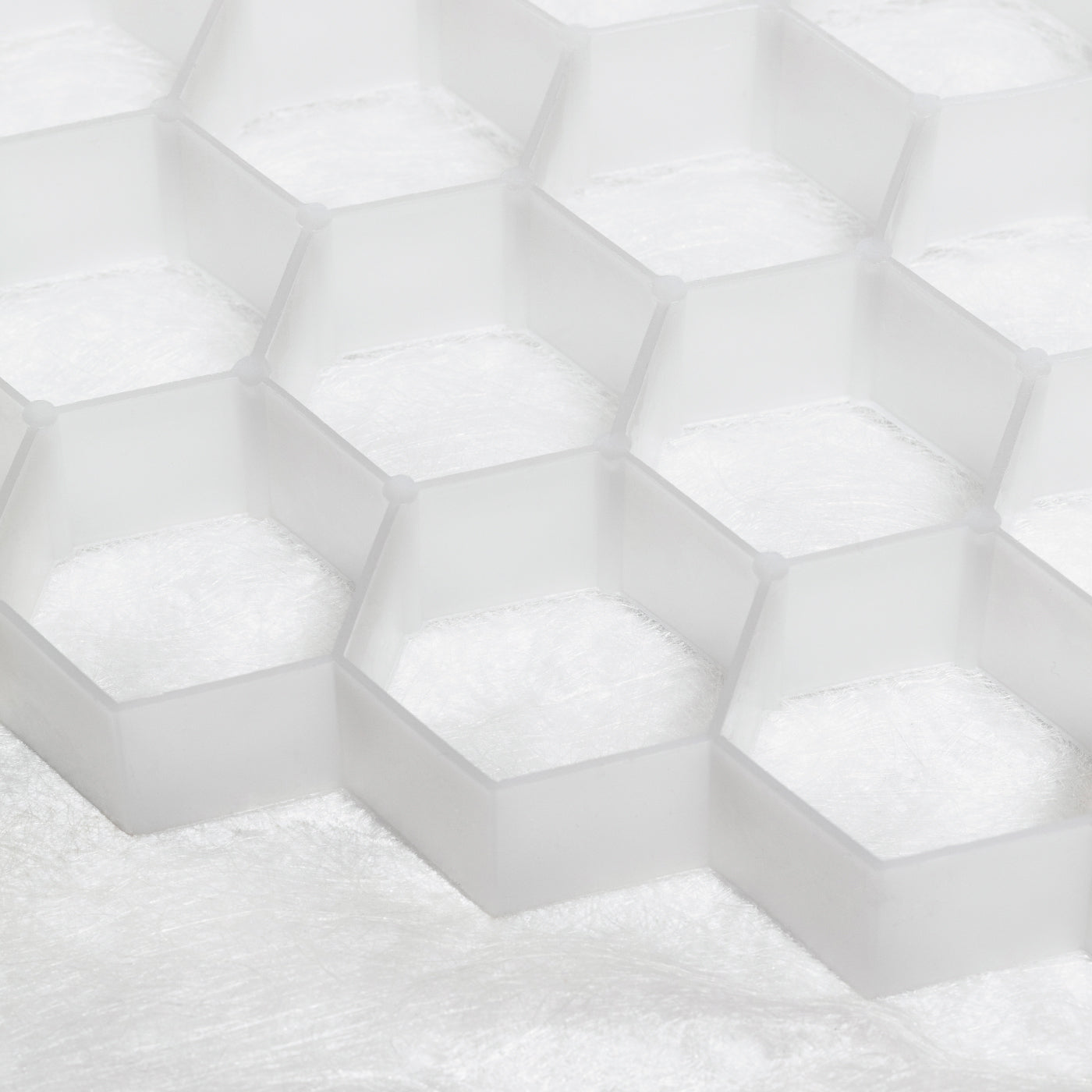 Close-up of white hexagonal tiles with a textured surface - the Core Path Pro substrate support system