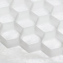 Close-up of white hexagonal tiles with a textured surface - the Core Path Pro substrate support system